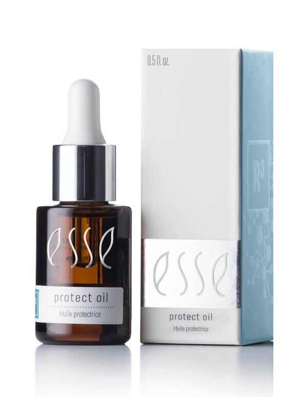 A 0.5 fl oz brown glass bottle with a dropper cap, labeled "Esse Protect Oil," is positioned beside its matching rectangular box. The minimalist design on the box incorporates white and light blue colors with text displaying the same product name.
